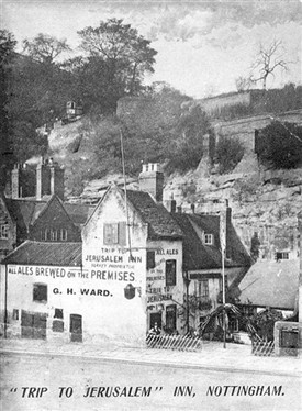 17th century inn with sandstone cliff behind, where beer was stored in caves