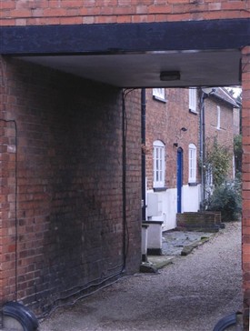 Photo:View through the archway between Nos.11 and 15 Church Street showing the yard and 18th century cottages beyond.  A possible location for Bingham's first theatre.