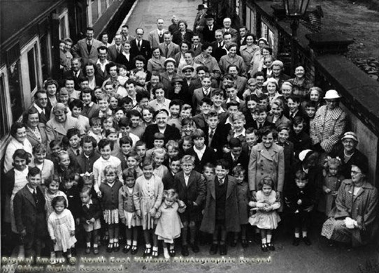 Photo:A happy group of children and adults at (we believe) Newark's Northgate railway station in the 1950s.  Are you in the picture?  Can you help us identify anyone seen here, and what was the reason for the outing?