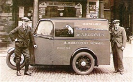 Photo:Above: Coynes' first motorised (3-wheeled) delivery vehicle.  Pictured outside the shop in the early 1930s are my uncle Jack Maidlow (left) and Len Coyne on the right.  The van was painted in Sherwood Foresters colours - green with red panels and gold lettering.  The picture left also shows Len Coyne in the early 1930s beside a selection of 'brand new and boxed' His Master's Voice table-top valve wireless sets.  One top of the pile is a box containing a separate 'all purpose' loudspeaker.