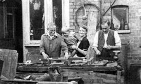 Photo:This photo, dated 1945, was taken at the back of 36 Swinderby Road, Wembley, Middlesex, with (from left to right) my maternal grandfather (who I called 'Pop'), my mother and Pop's brother, my Uncle Sid, who was an in-patient at Springfield Mental Hospital, near Tooting, in south London. He was admitted in 1922 and spent the last years of the First World War as a prisoner of war in Persia (modern Iran) Pop was a self-employed plumber and the back room of the house was his workshop and was the same when he died in 1976. He avoided call-up during the First World War and I am very proud of him for this fact alone. He was a kind and gentle man. My mother wasn't married when I was born and I never knew my father or who he was. This photograph was placed in the London Borough of Brent Archives, along with other family photographs, by my Uncle Frank, Sid's son, a few years ago. 'The Howards' were well known in Wembley, so I grew up listening to family and friends talking about people and events, past and present. How could I not become interested in local history? I bought my mother a 'History of Wembley' in 1952 as a birthday present from my paper-round money. It came back to me when she died in 2006 and in 1957, my Sunday School prize was 'The Book of Harrow', so I must have been showing an interest of sorts even then. It feels odd to be part of a 'archive' and the only person in a photograph who is still alive.