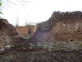Photo:A section of mud wall prior to repairs